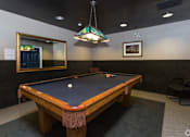 Thumbnail 2 of 23 - A pool table with a green cloth and a white ball in the middle.