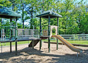 Thumbnail 23 of 23 - A playground with a slide and two gazebos.