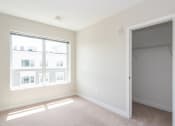 Thumbnail 12 of 20 - Large bedrooms and closet with carpeted flooring