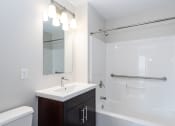 Thumbnail 19 of 20 - bathroom with tiled showers and bright vanity