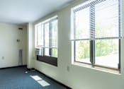 Thumbnail 5 of 12 - A room with a window and a wall-mounted speaker.