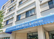 Thumbnail 1 of 12 - A building with a blue awning that says School Street Apartments.