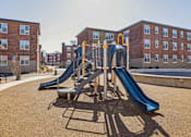 Thumbnail 8 of 17 - A playground with a blue slide and a yellow and white climbing frame.