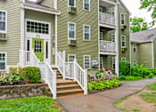 Thumbnail 14 of 19 - The Front Entry of a Apartment building with stairs and a porch at Station Pointe Apartments, Mansfield, Massachusetts