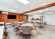 Thumbnail 7 of 17 - A conference room with a long table and chairs.