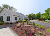 Thumbnail 2 of 14 - Building Exterior with Beautiful Landscaping at Mansfield Meadows Apartments.