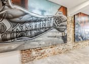 Thumbnail 9 of 17 - A mural of a muscular arm with the word "Romeo" written on it.