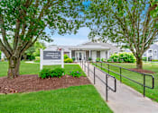 Thumbnail 14 of 16 - the preserve at ballantyne commons community entrance with trees and a fence at Blue Hills Village, Canton, MA