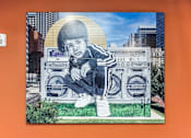 Thumbnail 15 of 17 - A mural of a person sitting on a boombox.