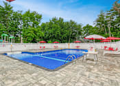 Thumbnail 15 of 19 - Community Swimming Pool with chairs For Resident Usage at Station Pointe Apartments, Mansfield, MA, 02048