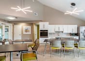 Thumbnail 5 of 19 - Community room with tables and chairs at Station Pointe Apartments, Mansfield, MA, 02048