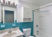 Thumbnail 4 of 15 - A white toilet sits next to a sink in a bathroom at Edmands House, Massachusetts, 01701