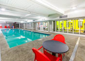 Thumbnail 13 of 18 - a swimming pool with a table and chairs next to it at Royal Worcester Apartments, Massachusetts