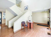 Thumbnail 4 of 12 - Entryway with staircase and reception desk at Blue Ridge Estates Apartments, Virginia