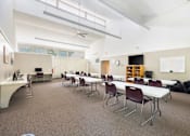 Thumbnail 2 of 12 - Community classroom with tables and whiteboard at Blue Ridge Estates Apartments, Virginia, 23225