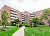 Thumbnail 17 of 17 - A large red brick building with a walkway in front of it at Edmands House, Framingham, 01701