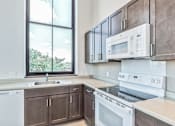 Thumbnail 1 of 7 - an empty kitchen with white appliances and a window at Letsche School, Pittsburgh, PA