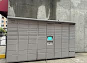 Thumbnail 4 of 8 - A grey Amazon vending machine with a green screen on the front.
