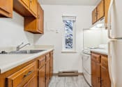 Thumbnail 9 of 12 - Kitchen With Wooden Cabinetry  at Pheasant Hill Estates, Harrisburg, PA