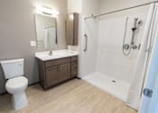 Thumbnail 5 of 12 - A white toilet sits next to a sink in a bathroom. at 35 Broadway Apartments, Menands