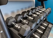 Thumbnail 9 of 12 - A set of dumbbells are arranged on a rack. at 35 Broadway Apartments, Menands, 12204