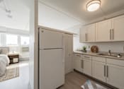 Thumbnail 2 of 15 - Modern kitchen with white cabinets and stainless appliances at Baystate Place Apartments, Springfield, 1104