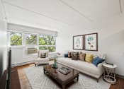 Thumbnail 1 of 15 - Bright living room with comfortable seating at Baystate Place Apartments, Springfield