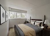 Thumbnail 4 of 15 - Bedroom with dark wood bed frame at Baystate Place Apartments, Massachusetts, 1104