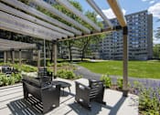 Thumbnail 8 of 15 - Outdoor seating area with pergola and gardens at Baystate Place Apartments, Massachusetts