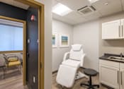 Thumbnail 14 of 15 - Medical treatment room with examination chair at Baystate Place Apartments, Springfield, 1104