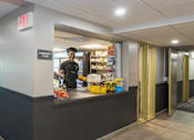 Thumbnail 13 of 15 - Community store with staff member and snacks at Baystate Place Apartments, Springfield Massachusetts