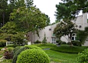Thumbnail 6 of 12 - Manicured grounds with mature trees and shrubs at Blue Ridge Estates Apartments, Richmond, VA 23225