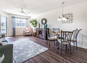 Thumbnail 10 of 14 - A living room with a dining table and chairs Fishermans Landing Apartments in Ormond Beach, FL.