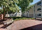 Thumbnail 5 of 21 - Courtyard with Bench  at Blake Estates Apartments in Hyde Park, Massachusetts