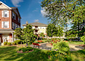 Thumbnail 8 of 14 - a park with a bench in front of a building  at Monterey Place, New Haven, CT, 06511