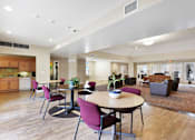 Thumbnail 7 of 17 - Resident Seating Area With Tables And Chairs at Creekwood Apartments, Watertown, NY.