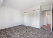 Thumbnail 18 of 21 - A room with white walls and a grey carpet.