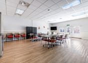 Thumbnail 14 of 21 - A conference room with a long table and chairs.