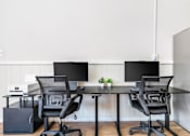 Thumbnail 11 of 21 - A black chair is placed in front of a black monitor.
