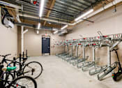 Thumbnail 13 of 14 - A bike rack with bikes and a scooter in a garage