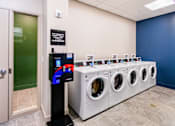 Thumbnail 14 of 14 - A row of washing machines in a laundromat