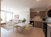 Thumbnail 10 of 12 - A modern kitchen with a dining table and chairs. at The Anne M. Lynch Homes at Old Colony, South Boston, Massachusetts