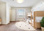 Thumbnail 5 of 17 - a bedroom with two bunk beds and a round rug at Creekwood Apartments, Watertown, 13601