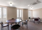 Thumbnail 5 of 12 - Community room with tables and chairs at 13 State Street, Schenectady NY
