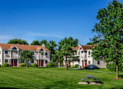 Thumbnail 2 of 12 - Exterior View of Apartments with Outdoor Picnic Table and Green Space. at Pheasant Hill Estates, Harrisburg, PA, 17110