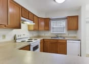 Thumbnail 9 of 15 - Kitchen Layout with Updated Modern Appliances, Wooden Cabinetry  at Summit Wood Apartments, Watertown, 13601