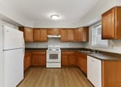 Thumbnail 11 of 15 - Kitchen Layout with Updated Modern Appliances, Wooden Cabinetry  at Summit Wood Apartments, Watertown, 13601
