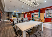 Thumbnail 11 of 15 - A large conference room with a long table and chairs at The Cordovan at Haverhill Station, Haverhill, MA