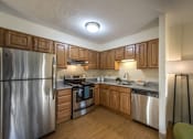 Thumbnail 2 of 6 - kitchen with wood cabinets and stainless steel appliances at Waterford Place. at Waterford Place, Massachusetts