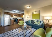 Thumbnail 1 of 6 - a living room with a couch and a table  at Waterford Place, Massachusetts, 02118